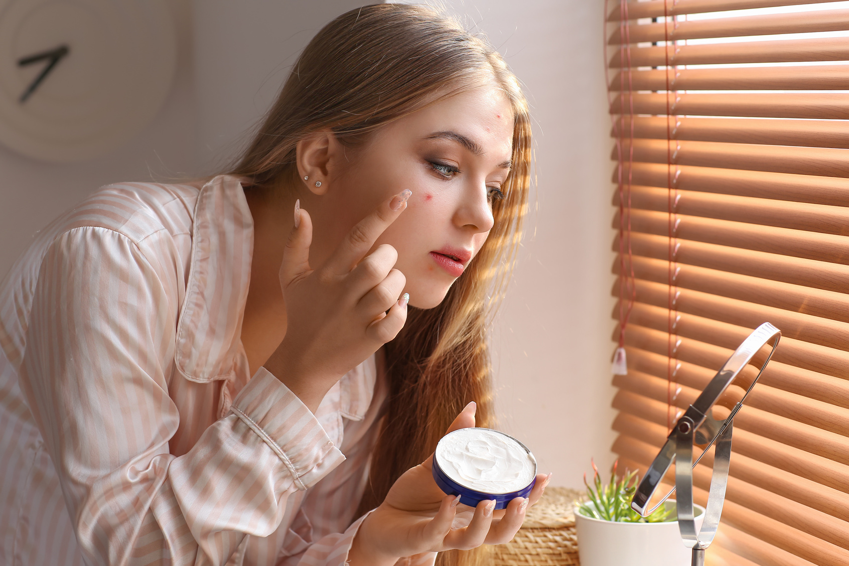 Teenage Girl Applying Remedy for Acne at Home