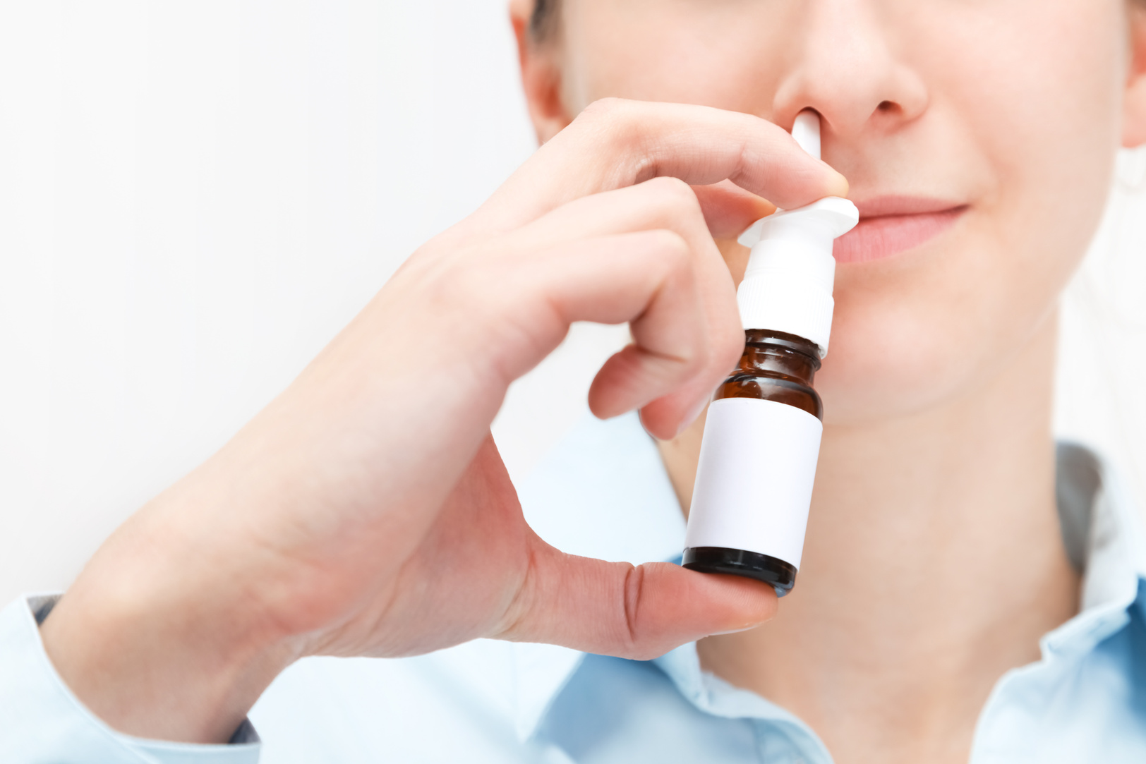Woman Using Nasal Spray