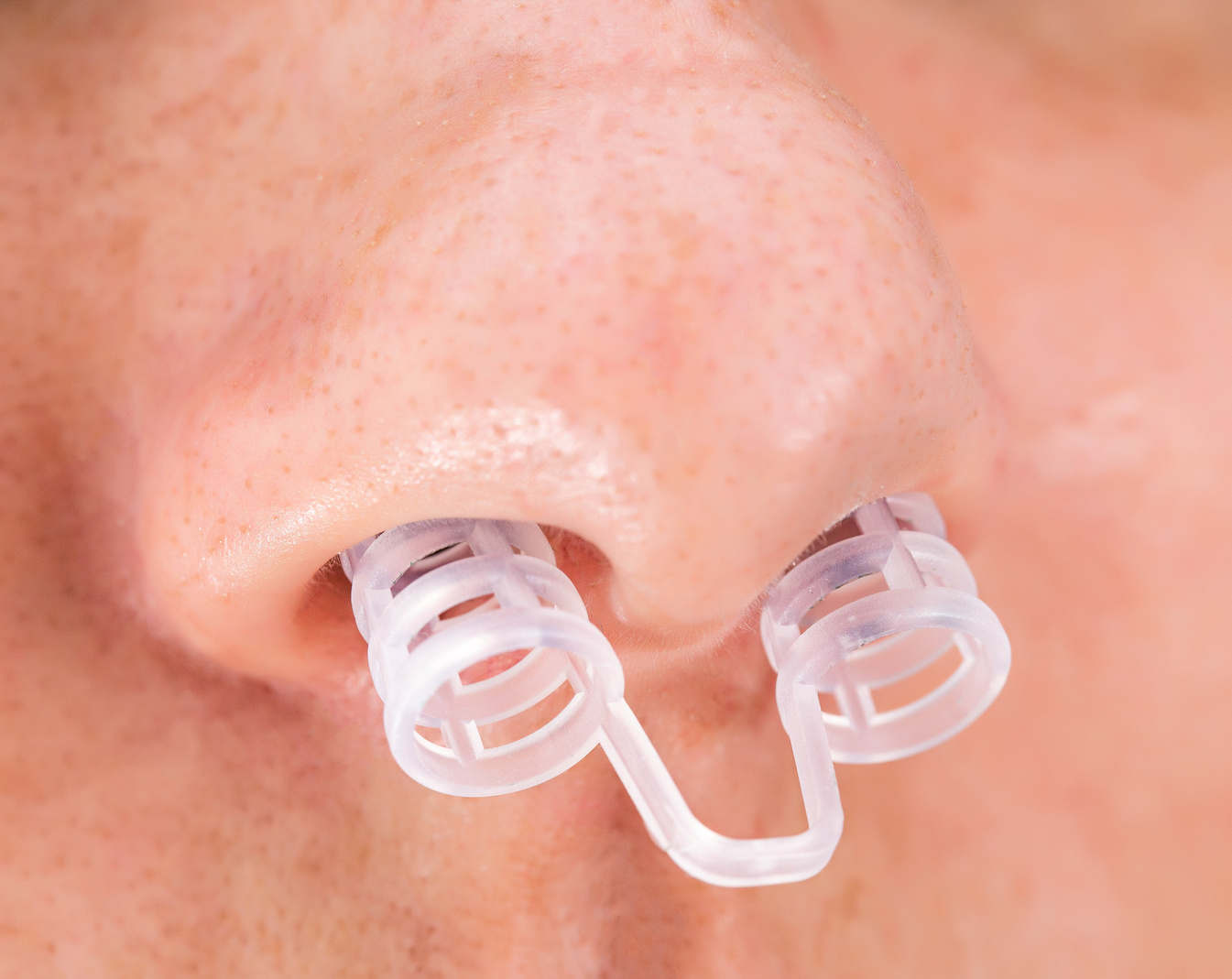 A device against snoring in a person's nose, close-up, macro. Sleep problems